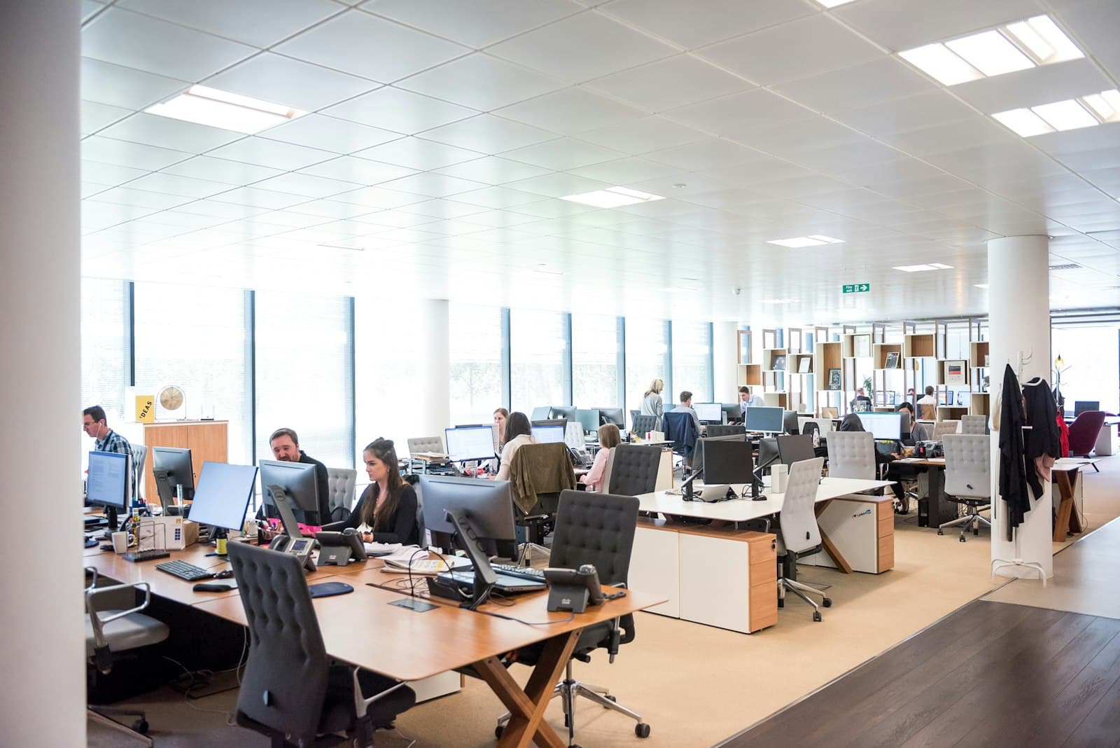 A bright, open-plan office with teams at work across the floor